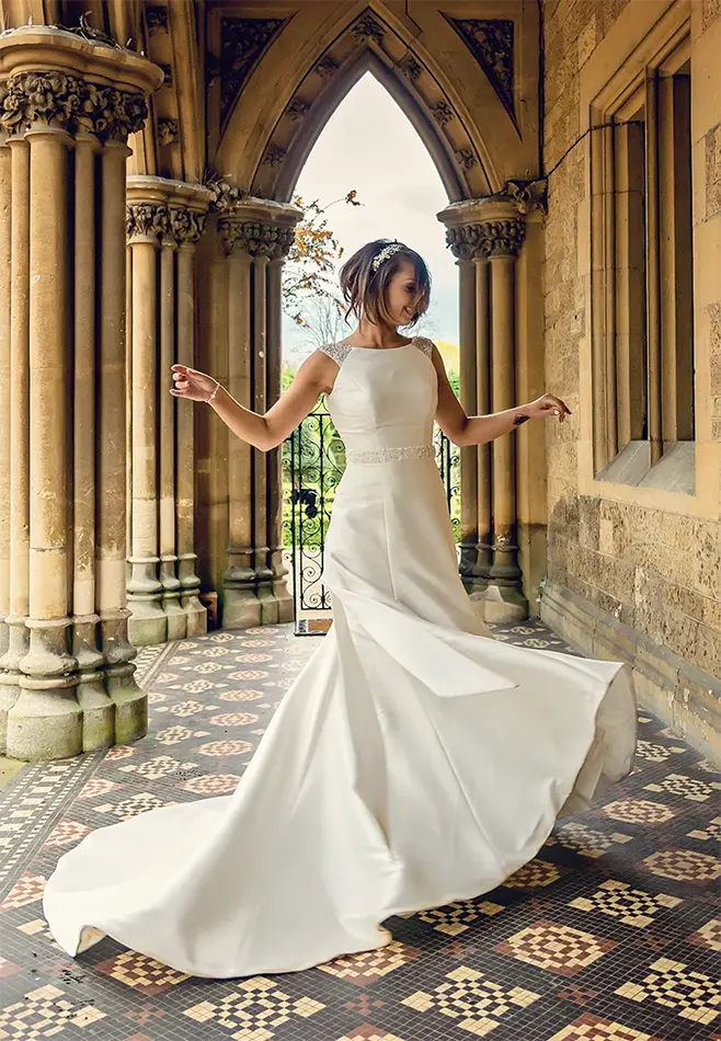 Bride spinning in her dress in summer gardens