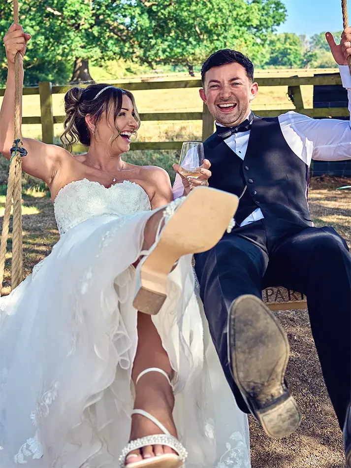 Couple having fun on a swing in a Worcester park