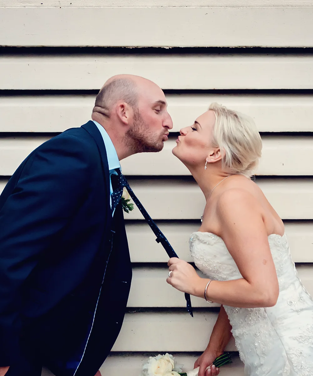 Fun newlyweds outside a retro Kidderminster wedding manor